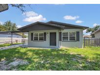 Charming single-story home with gray trim, a carport, and tidy front yard at 602 Taylor Blvd, Winter Haven, FL 33880