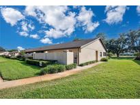 Charming villa featuring lush landscaping, private courtyard, and covered front entry at 2256 Firestone Pl, Winter Haven, FL 33884