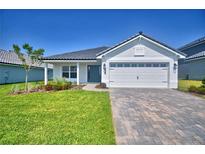 Charming single-story home features a neat lawn, brick driveway, and a two-car garage at 4682 Grandview Glen Dr, Auburndale, FL 33823
