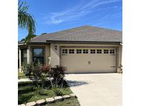 Charming single-story home with a well-maintained front yard, landscaping, and a two-car garage at 5514 Maggiore Blvd, Lakeland, FL 33805
