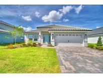 Charming single-story home with a tile roof, paver driveway, and well-manicured landscaping at 4688 Grandview Glen Dr, Auburndale, FL 33823