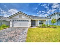 Charming single-story home with a two-car garage, lush lawn, and inviting front entrance at 4700 Grandview Glen Dr, Auburndale, FL 33823
