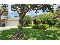 Charming single-story home with lush landscaping, mature trees, and a well-maintained lawn at 108 Lake Region N Blvd, Winter Haven, FL 33881