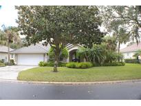 Charming single-story home featuring a well-manicured lawn and lush landscaping at 108 Lake Region N Blvd, Winter Haven, FL 33881