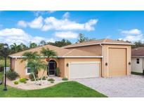 Charming single-story home featuring a three-car garage, manicured landscaping, and lush green lawn at 3802 Litchfield Loop, Lake Wales, FL 33859