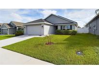 Charming single-story home with well-manicured lawn and inviting curb appeal at 147 Krenson Bay Loop, Winter Haven, FL 33881