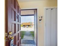 View from the doorway of the home, showing the entryway and view outside at 1836 N Crystal Lake Dr # 46, Lakeland, FL 33801