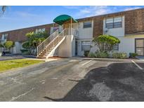 Front view of condo building with stairs and parking at 6123 Topher Trl # 63C, Mulberry, FL 33860