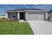 Charming single-story home with a well-manicured lawn and a two-car garage at 468 Ituna Cir, Winter Haven, FL 33881