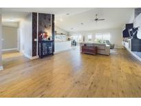 Open-concept living room with vaulted ceiling, wood floors, and comfortable modern furnishings at 1155 Towergate Cir, Lake Wales, FL 33853