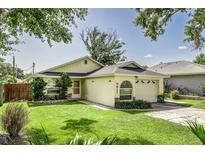 Charming single-story home with a well-manicured lawn and attached garage at 4617 S Devon Ave, Lakeland, FL 33813