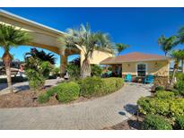 The entrance welcomes you with palms, landscaping and a charming covered entryway at 535 Narrow Pond Rd, Polk City, FL 33868