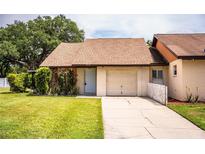 Charming single-story home featuring an attached garage, well-maintained lawn, and simple landscaping at 5058 Cimarron Dr, Lakeland, FL 33813