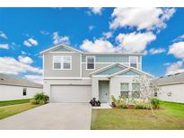 Charming two-story home with a well-manicured lawn and attached two car garage at 5460 Siltstone St, Lakeland, FL 33811