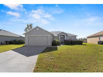 Single-story house with attached garage and a spacious lawn at 8183 Westmont Terrace Dr, Lakeland, FL 33810