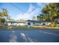 Charming single-story home with a well-manicured lawn and inviting entrance with fresh landscape at 410 N Tecumseh Ave, Fort Meade, FL 33841