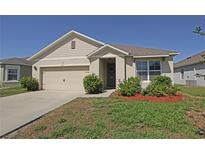 Charming single-story home featuring a well-manicured lawn and neutral color palette at 433 Montego Bay Dr, Mulberry, FL 33860