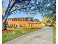 Two-story brick home with a large yard and long driveway at 5171 Deeson Pointe Ct, Lakeland, FL 33805