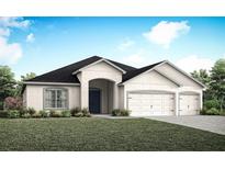 Single-story home with two-car garage and landscaped lawn at 557 Silver Course Run, Ocala, FL 34472