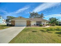 Single-story home with stone accents and landscaped yard at 6004 Greenleaf Cir, Winter Haven, FL 33884
