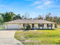 Single-story house with attached garage, brick accents, and a well-maintained lawn at 7101 Scenic Pl, Lakeland, FL 33810