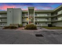 Three-story condo building with balconies and secure entry, surrounded by well-maintained landscaping at 1130 N Lake Parker Ave # A205, Lakeland, FL 33805