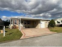 Single-story home with carport and landscaped lawn at 2356 Peavine Cir # 1017, Lakeland, FL 33810