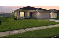 One-story house with a landscaped lawn and attached garage at 4018 Sundance Place Loop, Mulberry, FL 33860