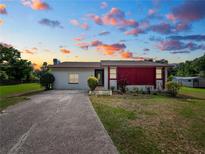 One-story home with a red accent wall and a spacious yard at 6929 Farris Dr, Lakeland, FL 33811