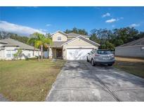 Two-story house with a driveway and landscaping at 8309 Porch Ct, Lakeland, FL 33810