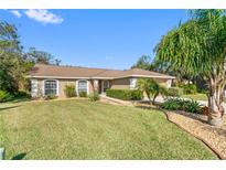 Single-story home with landscaped lawn and palm trees at 138 Brandy Chase Blvd, Winter Haven, FL 33880