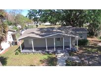 Inviting single-story home with a covered front porch and well-maintained lawn at 3016 Hutchins St, Eaton Park, FL 33840