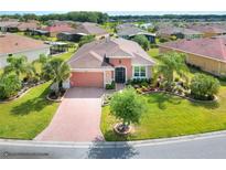 Aerial view of a single-Gathering home with landscaped yard and paved driveway at 453 Treviso Dr, Kissimmee, FL 34759