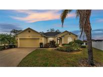 Beautiful yellow house with a landscaped yard and attached garage at 7406 Summit Pl, Lakeland, FL 33810