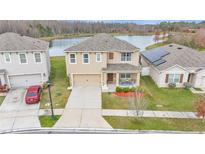 Two-story house with solar panels and lake view at 1915 Pristine Loop, Lakeland, FL 33811