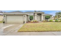 House exterior featuring a two-car garage and well-manicured lawn at 2105 Normandy Heights Ln, Winter Haven, FL 33880