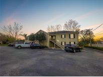 Beautiful two-story apartment building with ample parking and manicured landscaping during a colorful sunrise at 223 Windsor St # 3A, Lakeland, FL 33803