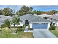 Single-story home with a gray roof, attached garage, and landscaped yard at 3618 Highland Fairways Blvd, Lakeland, FL 33810