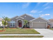 Single-story house with a two-car garage and attractive landscaping at 4308 Whistlewood Cir, Lakeland, FL 33811