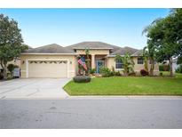 Beautiful one-story home with a two-car garage and manicured lawn at 6550 Evergreen Park Dr, Lakeland, FL 33813