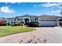 Gray two-story house with a three-car garage and landscaped yard at 7068 Island Lake Ln, Lakeland, FL 33813