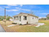 Newly renovated home with a screened porch and landscaped yard at 865 S 9Th Ave, Bartow, FL 33830