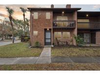 Brick townhouse with balcony and small front yard at 2369 Tom Jones St # 8, Orlando, FL 32839