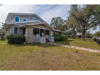 Charming two-story home with stone accents and a spacious lawn at 306 Avenue C Ne, Winter Haven, FL 33881