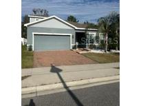 Single-story home with two-car garage and well-maintained lawn at 357 Siesta Vista Ct, Davenport, FL 33896