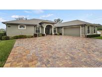 House exterior featuring a paver driveway and landscaping at 3604 Frentress Dr, Lakeland, FL 33812