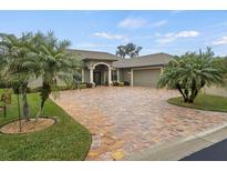 House exterior features a paver driveway, two palm trees, and a gray color scheme at 3604 Frentress Dr, Lakeland, FL 33812