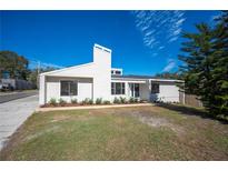 White single story home with landscaped lawn at 4718 Valley Hill Ct, Lakeland, FL 33813