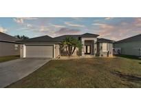 One-story home with attached garage and landscaped yard at 5181 Ashwood Dr, Lakeland, FL 33811