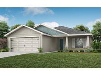 One-story home with a two-car garage and attractive landscaping at 1035 Aruba Ave, Mulberry, FL 33860